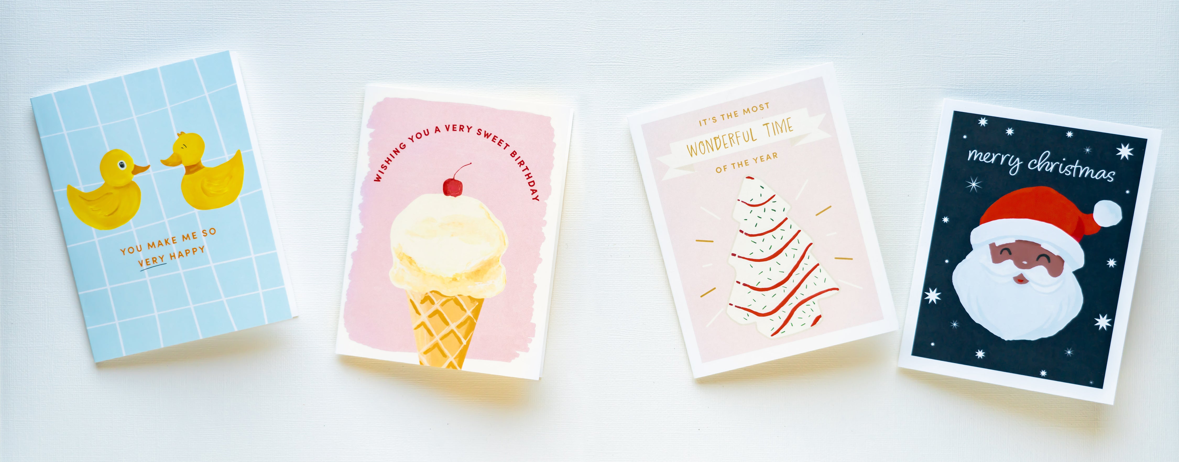 Four assorted greeting cards in a line